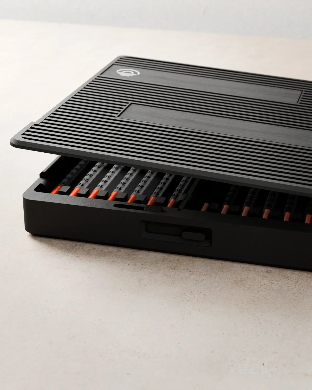 Close detail of the ribbed Routine Box lid lifting to reveal organized syringes