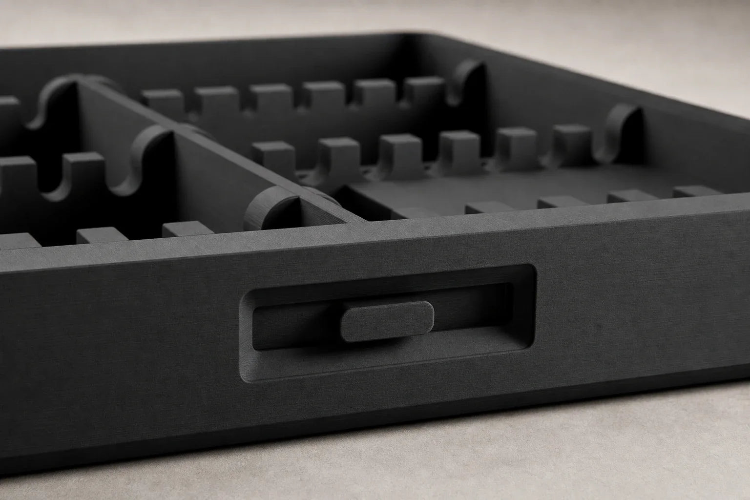 Close detail of the empty Routine Box tray, fitted dividers, and front latch