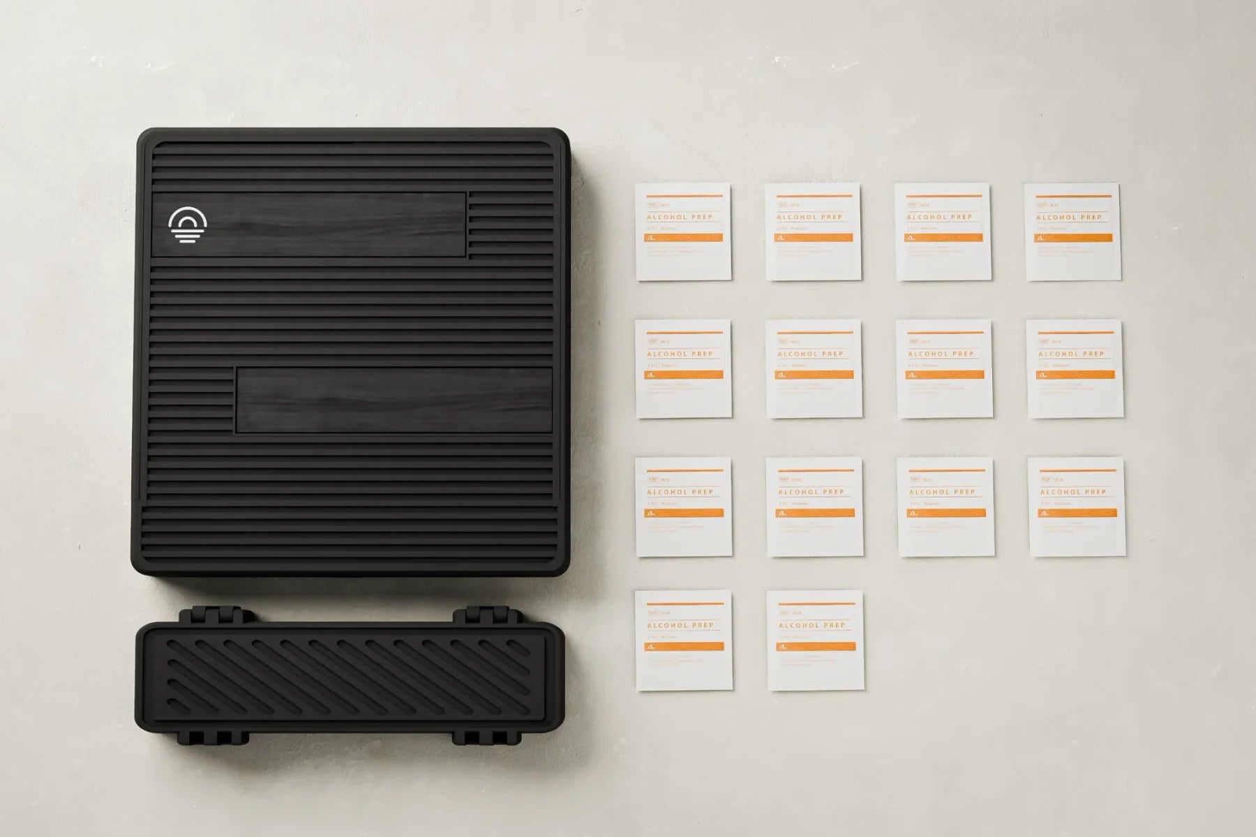 Flat lay of the Routine Box, travel case, and fourteen prep pads
