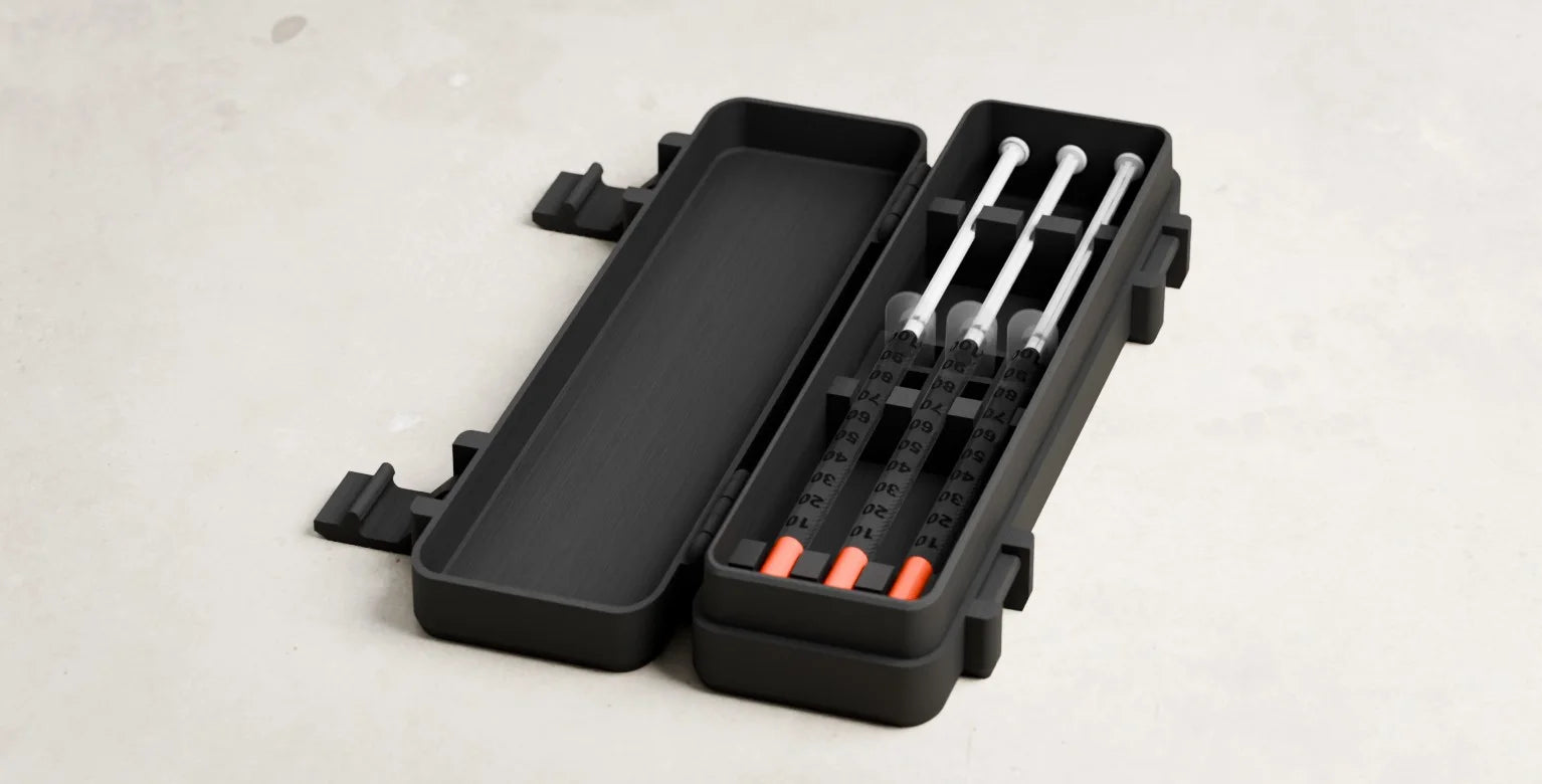 Travel case fully open with three capped syringes secured inside