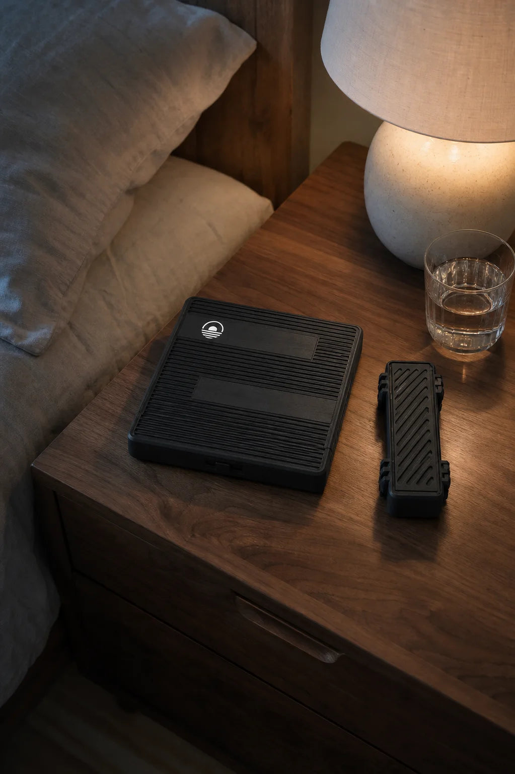 Routine Box and travel case stored on a walnut nightstand